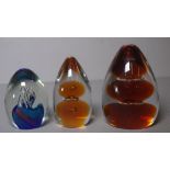 Three bubble glass paperweights