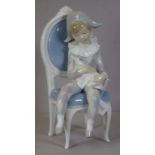 Lladro seated boy with cat figure