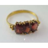Yellow gold and garnet ring marked 9K