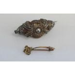 Two antique brooches including 9ct flower
