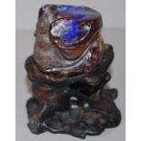 Carved opal quartz rat figure on wooden stand