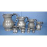 Set of eight antique pewter measuring pub mugs