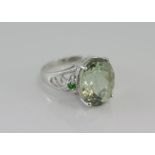 Silver and oval shaped green amethyst ring