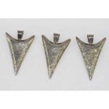 Three silver arrowhead pendants