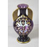 Antique twin handled purple glass vase