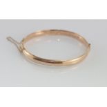 9ct rose gold, wax filled hinged bangle