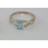 Silver and blue topaz ring