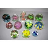 Twelve assorted glass paperweights