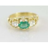 18ct yellow gold, oval emerald & 2 diamond ring