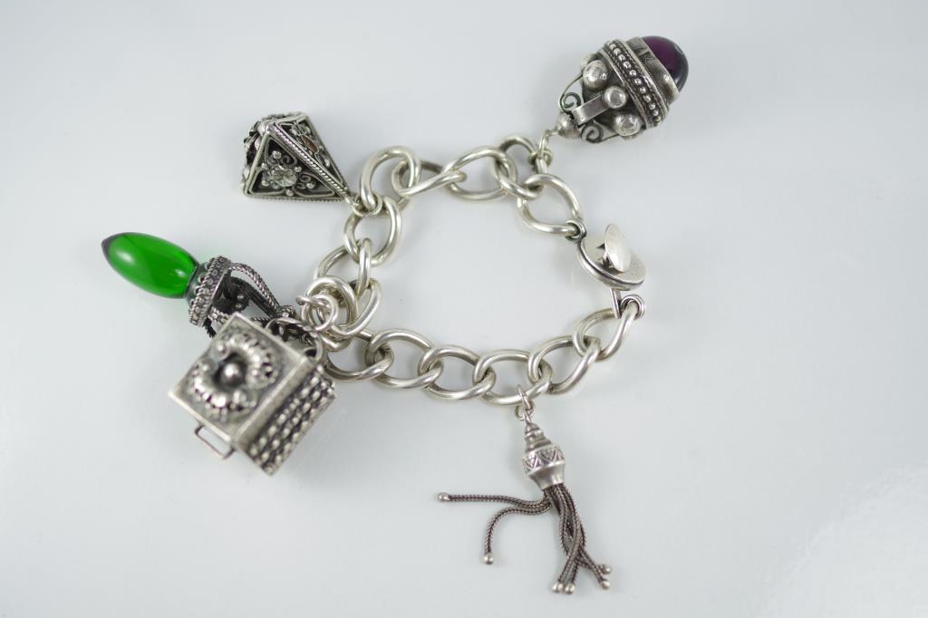 A chunky vintage Etruscan silver charm bracelet