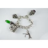 A chunky vintage Etruscan silver charm bracelet