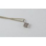 A delicate 9ct white gold and diamond pendant