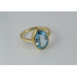 A gold and blue topaz ring