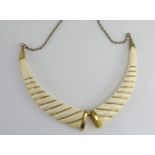 A vintage ivory and gold twist necklace
