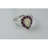 A silver, ruby and solid opal ring
