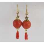A pair of dainty coral drop earrings