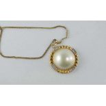 A yellow gold, mabe pearl and diamond pendant
