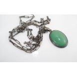 A silver and green stone pendant on chain