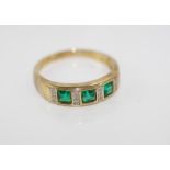 An emerald and diamond ring