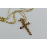 A gold necklace with cross