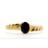 A yellow gold and sapphire ring