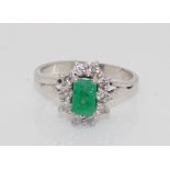 White gold, emerald and diamond cluster ring.