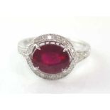 18ct white gold, oval ruby and diamond ring