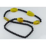 A matinee length Baltic amber and onyx necklace