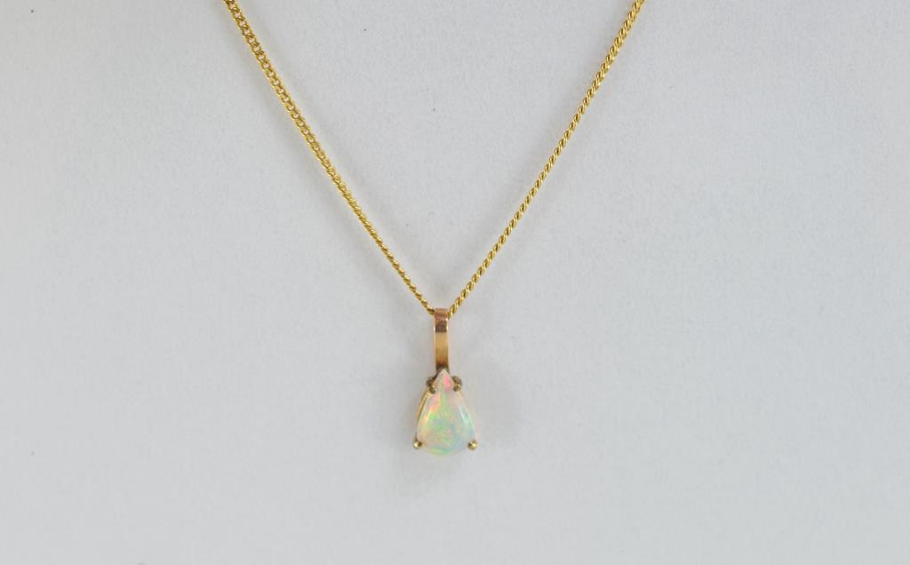 Solid opal and gold pendant on gold chain