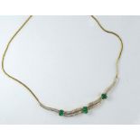 A gold, emerald and diamond necklace