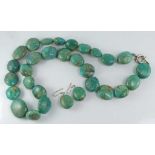 A knotted strand of turquoise beads