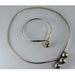 A silver ball collar and bracelet