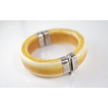 A vintage hinged ivory and silver bangle