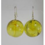 A pair of large yellow green Baltic amber earrings