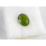 An unset facetted oval peridot