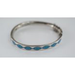 A silver and enamel hinged bangle