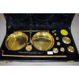 Boxed set of brass scales and weights