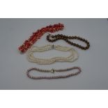 A quantity of pearl and faux pearl necklaces