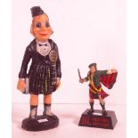 Two early plastic whisky advertising figures