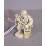 Antique Japanese ivory netsuke-man at water well