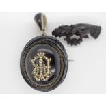 An antique Victorian carved jet mourning pendant