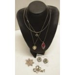 Three sterling silver chains with various pendants