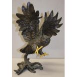 Cast metal owl in flight sculpture