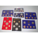 Seven annual proof/unc coin sets