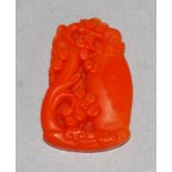 Chinese carved orange hard stone floral pendant