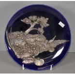 Ornate silver mount on a ceramic plate