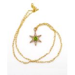 A gold star pendant and gold chain