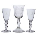 A large presentation wine glass and a pair of wine glasses: the former with bell shaped bowl