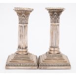 A pair of Victorian silver Corinthian column candlesticks, maker Goldsmith and Silversmiths Co, Ltd,