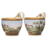 A pair of Meissen cabinet cups: of ogee form with high strap handles and finely painted with